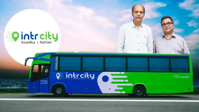 Image showing Manish Rathi, and Kapil Raizada, co-founders of IntrCity SmartBus, standing behind a bus with IntrCity branding