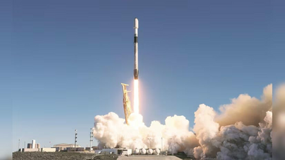 Image showing a rocket launching with flames and smoke against a clear sky