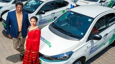 Image showing Sriram Kannan, founder and CEO, and Kavitha Ramachandra Gowda, co-founder and executive director of Routematic, standing beside cars with Routematic branding