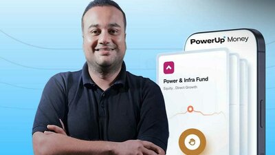 Image showing Prateek Jindal, founder and CEO of PowerUp Money, standing beside a mobile interface displaying PowerUp Money and Power and Infra Fund