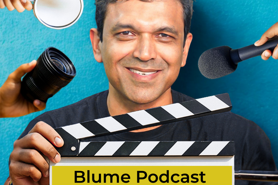 Slide showing BLUME PODCAST, Blume Podcast Season 4, With Karthik Reddy, with a clapperboard and multiple hands holding mic and objects around Karthik Reddy